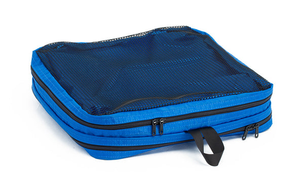 An empty and zipped closed Island (blue) Aether Large Laundry Aeronaut 30 Packing Cube showing the mesh side.